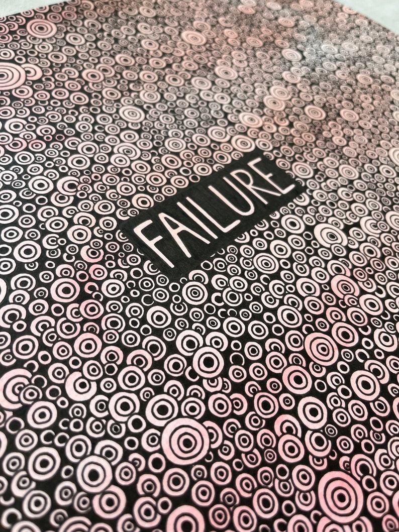 May include: Black and white illustration of a pattern of concentric circles with a pink gradient. The word "FAILURE" is written in white letters on a black rectangle.