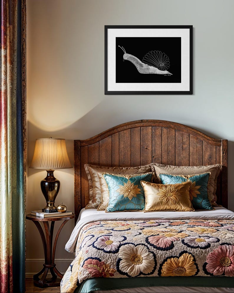 May include: A framed wall art print featuring a white line drawing of a snail on a solid black background. The snail has a detailed shell and extended antennae. The artwork is enclosed in a simple black frame with a white mat border.