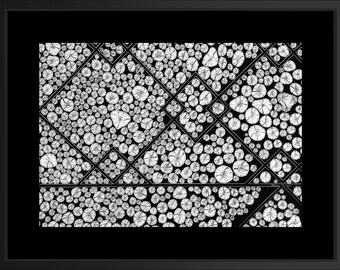 May include: A black and white framed print featuring a geometric pattern composed of numerous circular cross-sections of wood logs. The circular shapes are arranged within a series of intersecting diamond and triangular outlines, creating a structured, repeating visual composition.