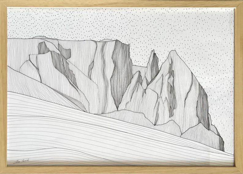 May include: A framed black and white line art drawing of a mountain range. The artwork features intricate vertical lines defining the rocky peaks and slopes, set against a sky filled with small black dots. The piece is enclosed in a light wood frame.