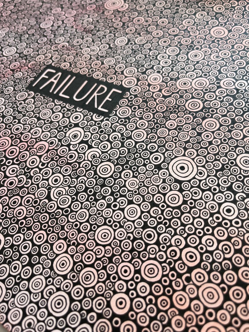 May include: Black and white abstract art print with a repeating pattern of concentric circles. The word "FAILURE" is written in white letters on a black rectangle at the top of the print.