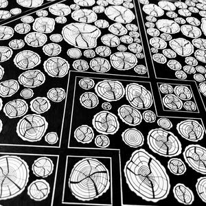 May include: A black and white graphic illustration featuring a repeating pattern of circular tree ring cross-sections. The design is organized into geometric segments separated by thin white lines, creating a structured grid of organic wood grain motifs.