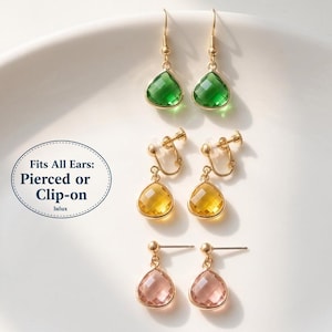 May include: An assortment of gold-toned earrings with teardrop-shaped gemstones in green, yellow, and pink. The image includes pierced and clip-on styles. Text on the image reads: Fits All Ears: Pierced or Clip-on.