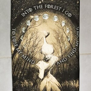 May include: A sepia-toned poster with a forest scene and a woman reaching towards a light. The text reads "Into the forest I go to lose my mind and find my soul." The design includes moon phases and stars.