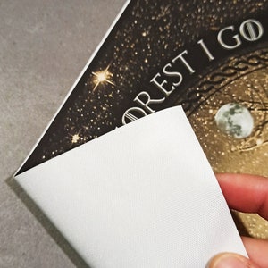 May include: A canvas print with the text "FOREST I GO" in white lettering. The background features a starry night sky with a moon and a compass design. The canvas is white on the back.