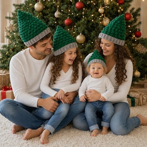May include: A set of four matching pointed hats featuring a textured green knit body with a solid grey ribbed brim. Each hat is designed with a tall, conical shape and a thick, folded cuff, providing a uniform look for a group of four individuals.