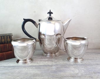 Vintage three-piece silver plate tea or coffee set with pot, sugar bowl and milk jug.