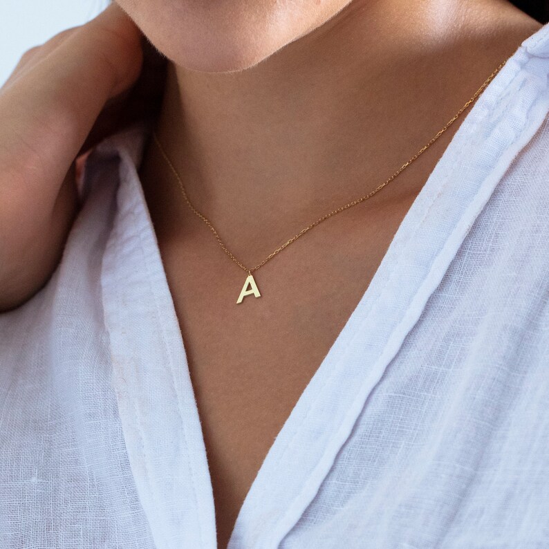 a initial necklace, a letter pendant