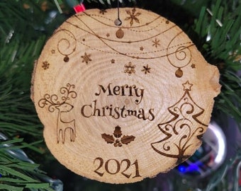 May include: A wooden Christmas ornament with a reindeer, a Christmas tree, and the text "Merry Christmas 2021".