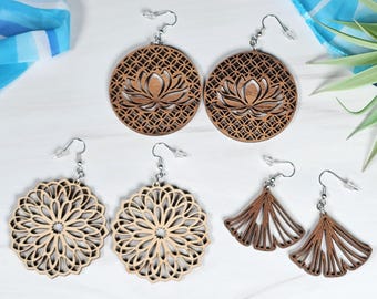 May include: A collection of wooden earrings in various designs. Two pairs feature a lotus flower design, two have a floral pattern, and two are fan-shaped. The earrings are light brown and dark brown, with silver-colored hooks.