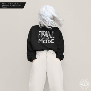 May include: Black sweatshirt with white text that reads "Fireball Mode" and a graphic of a hand holding a fireball.