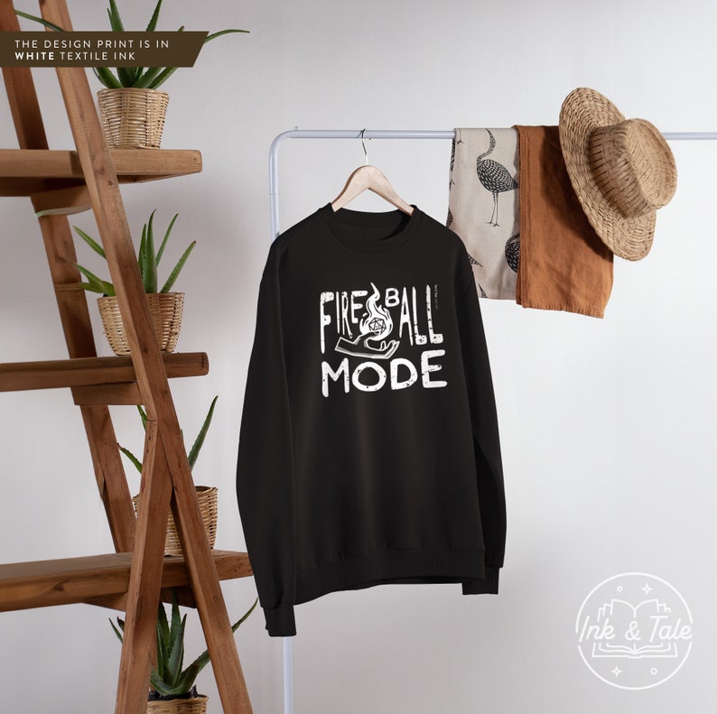 May include: Black sweatshirt with white text that reads "Fireball Mode" and a graphic of a hand holding a fireball.