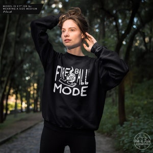 May include: Black sweatshirt with a white graphic print of a hand holding a flaming dice with the text "Fireball Mode".