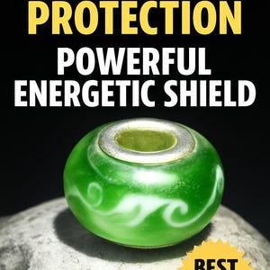 May include: Green glass bead with a silver ring and white swirl design. The bead is sitting on a gray rock. The text "BEST SELLER" is on a yellow starburst.