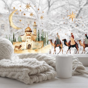 May include: A cozy winter scene with a watercolor illustration of a Middle Eastern town, a crescent moon, and stars. Three figures on camels are traveling across the scene. A white mug, yarn ball, and knitted blanket sit on a windowsill.