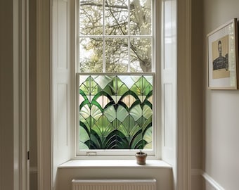 May include: A white window with a green stained glass panel depicting stylized leaves. The window is framed by white trim and sits above a white window seat with a radiator underneath. A small potted plant sits on the window seat.