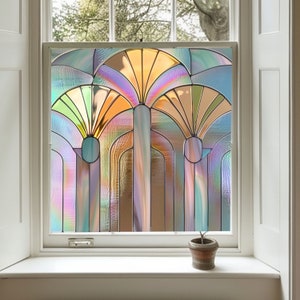 May include: A stained glass window film with a geometric design featuring three arches with a fan-shaped pattern in shades of green, orange, and purple.
