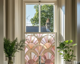 May include: A bathroom sink with a chrome faucet and a stained glass window with a pink and gold geometric design. Two potted plants are on either side of the sink.