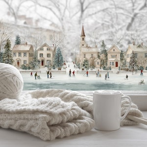 May include: A winter scene featuring a white mug, knitting needles, and a ball of yarn on a cable-knit blanket. The window shows a snowy village with people ice skating on a frozen pond.