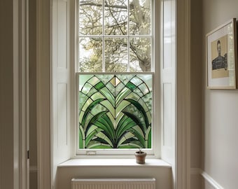 May include: A white window with a stained glass panel featuring a green and white geometric design. The window is framed by white trim and is set in a white wall. A small potted plant sits on the windowsill.