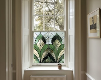 May include: A white window with a stained glass panel featuring a green and white geometric design. The window is set in a white frame and has a white windowsill. A small potted plant sits on the windowsill.