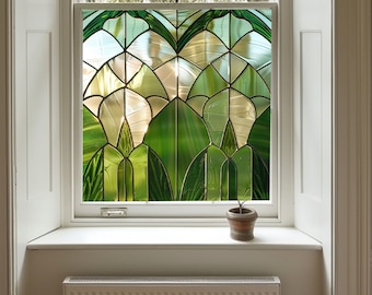 May include: A window with a stained glass design featuring green and white geometric shapes. The window is framed in white and has a white windowsill. A small potted plant sits on the windowsill.