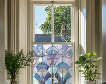 May include: A stained glass window film with a geometric design in shades of purple, blue, and white. The film is applied to a window in a bathroom with a sink and faucet.