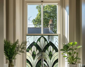 May include: A bathroom window with a stained glass panel featuring a geometric design in shades of green and white. The window is framed in white and the glass panel is set in a white frame.