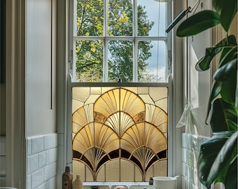 May include: A bathroom window with a stained glass design featuring a geometric pattern of gold and black leaves. The window is framed in white and has a view of green trees outside.