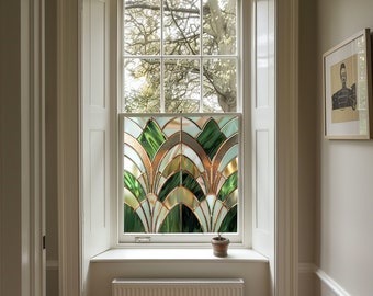 May include: A white window with a stained glass panel featuring a geometric design of green, gold, and white. The window is framed by white trim and is set in a white wall.