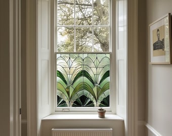 May include: A white window with a stained glass panel featuring a green and white geometric design. The window is set in a white frame and has a white windowsill. A small potted plant sits on the windowsill.