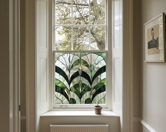 May include: A white window with a stained glass panel featuring a green and gold geometric design. The window is framed by white trim and is set in a white wall. A small potted plant sits on the windowsill.