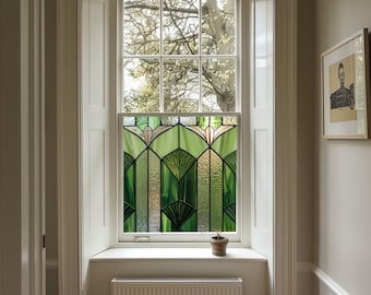 May include: A white window with a stained glass panel featuring green and gold geometric shapes. The window is framed by white trim and is set in a white wall. A small potted plant sits on the windowsill.