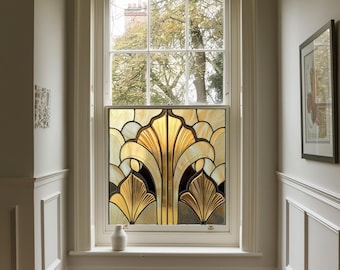 May include: A stained glass window with a geometric design in shades of gold and brown. The window is set in a white frame and is surrounded by white walls.