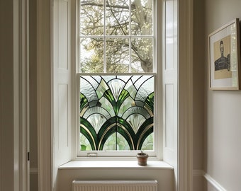 May include: A white window with a stained glass panel featuring a geometric design of green and gold leaves. The window is set in a white frame and has a white windowsill. A small potted plant sits on the windowsill.