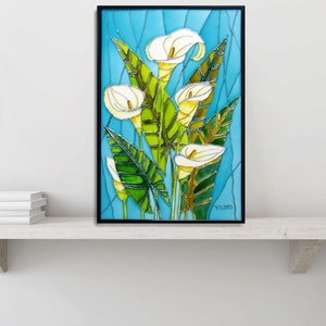 May include: A framed stained glass artwork featuring white calla lilies with green leaves against a blue background. The artwork is signed "TC 2013" in the bottom right corner.