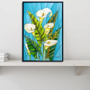 May include: A framed stained glass artwork featuring white calla lilies with green leaves on a blue background. The artwork is signed "T.C. 2013".