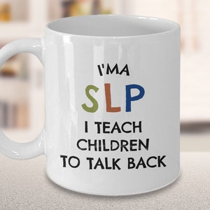 May include: White ceramic mug with a curved handle. The mug features the text "I'M A SLP I TEACH CHILDREN TO TALK BACK" in black, green, orange, and blue lettering. The mug is designed for speech-language pathologists.
