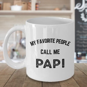 May include: White ceramic coffee mug with black text that reads "My favorite people call me Papi".