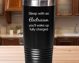 May include: Black stainless steel tumbler with a white inscription that reads "Sleep with an Electrician you'll wake up fully charged".