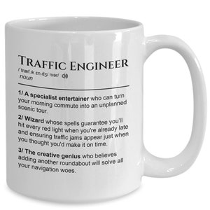 May include: White ceramic mug with a black design that defines a "Traffic Engineer" as a "specialist entertainer" who can turn a morning commute into an unplanned scenic tour, a "wizard" whose spells guarantee hitting every red light when already late, and a "creative genius" who believes adding another roundabout will solve all navigation woes.