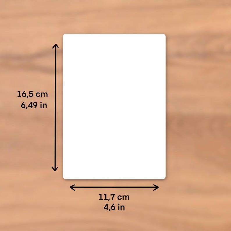 May include: A white rectangular product with rounded corners, measuring 16.5 cm in height and 11.7 cm in width. The dimensions are indicated by black arrows. The product is set against a wooden background.