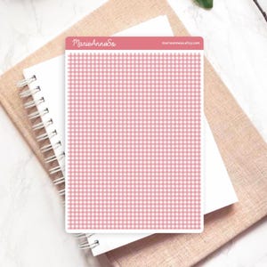 May include: A sheet of stickers with a pink and white gingham pattern. The stickers are rectangular and have rounded corners. The text "MarieAnneSo" and "marieanneso.etsy.com" are printed on the top of the sticker sheet. The sticker sheet is on top of a white spiral notebook and a tan notebook.
