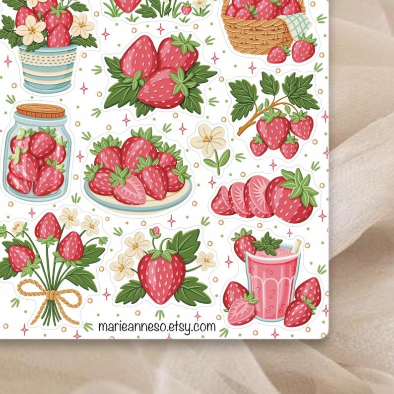 May include: A sticker sheet featuring various illustrations of strawberries. The designs include whole strawberries, sliced strawberries, strawberries in a jar, and strawberries in a basket. The background is white with small decorative elements.