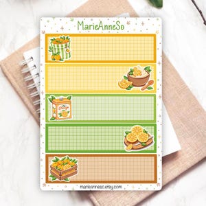May include: A decorative sticker sheet with an orange theme. The sheet features illustrations of oranges, a crate of oranges, and a container of orange-flavored cream. The text "MarieAnneSo" and "marieanneso.etsy.com" are also visible.