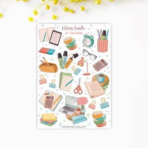 May include: A sheet of colourful stickers featuring various office supplies, including a laptop, a calculator, a book, a coffee cup, a lamp, a pencil case, a stapler, a pair of scissors, a notebook, a ruler, a tape dispenser, and a clock. The stickers are designed for use in planners, journals, and other paper goods. The text on the sheet reads "MarieAnneSo AT THE DESK".