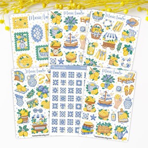 May include: A collection of decorative stickers featuring lemon and blue floral designs. The stickers include illustrations of lemons, sailboats, teacups, and tiles. The text "Marie Anne So" and "Citrus Garden" are visible.