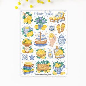 May include: A sticker sheet featuring various lemon-themed illustrations. Includes a sailboat, a lounge chair, a teacup, a scale, a cutting board, and a watering can, all with lemons. The sheet also has the text "Citrus Garden" and "marieanneso.etsy.com".
