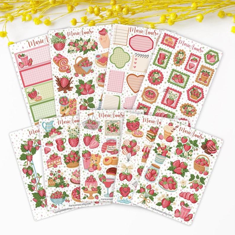 May include: A collection of decorative sticker sheets featuring strawberry-themed illustrations. The stickers include images of strawberries, desserts, and other related designs. The color palette is primarily pink, red, and green, with a white background. The stickers are arranged in a fan-like pattern.
