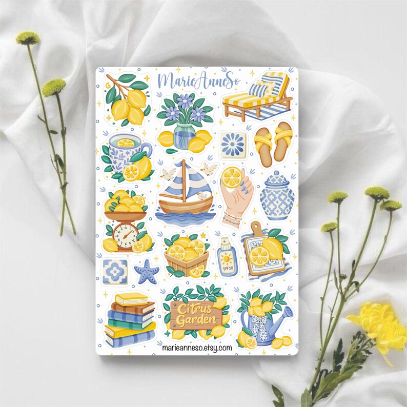 May include: A sticker sheet featuring various lemon-themed illustrations. Designs include lemons, a sailboat, a teacup, a watering can, and a sign that reads "Citrus Garden". The sticker sheet has the text "marieanneso.etsy.com".